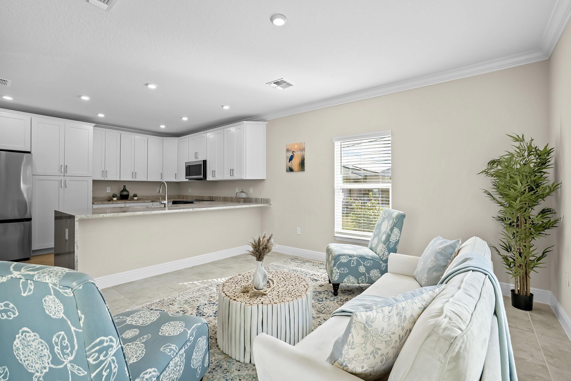 418 Easy Street Sebastian, FL 32958 - Photo 22 of 42 a kitchen with stainless steel appliances granite countertop a refrigerator sink and white cabinets