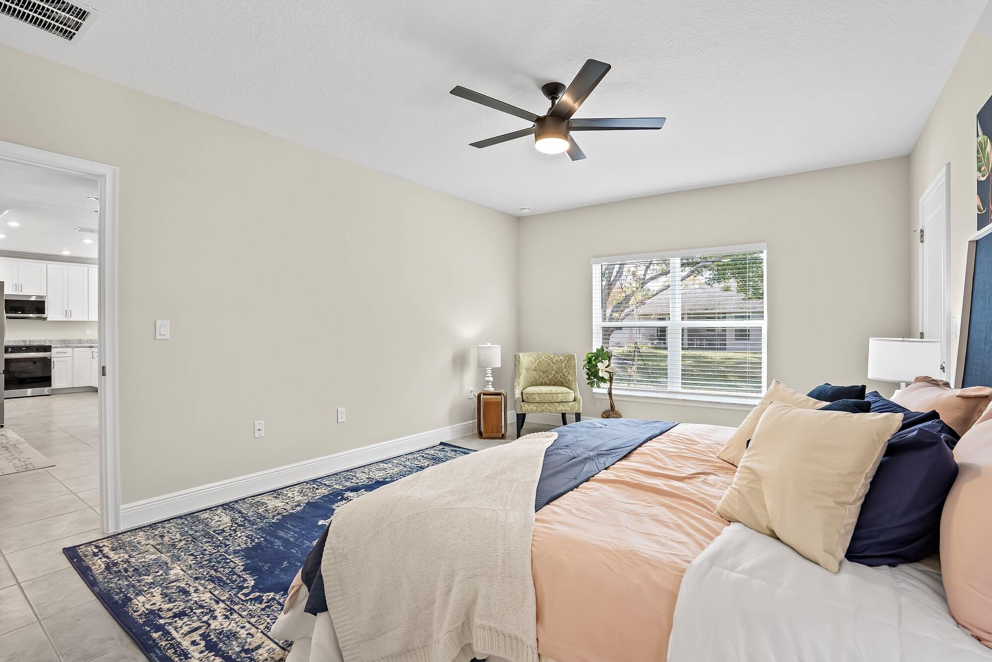 418 Easy Street Sebastian, FL 32958 - Photo 25 of 42 a bedroom with a large bed and a window