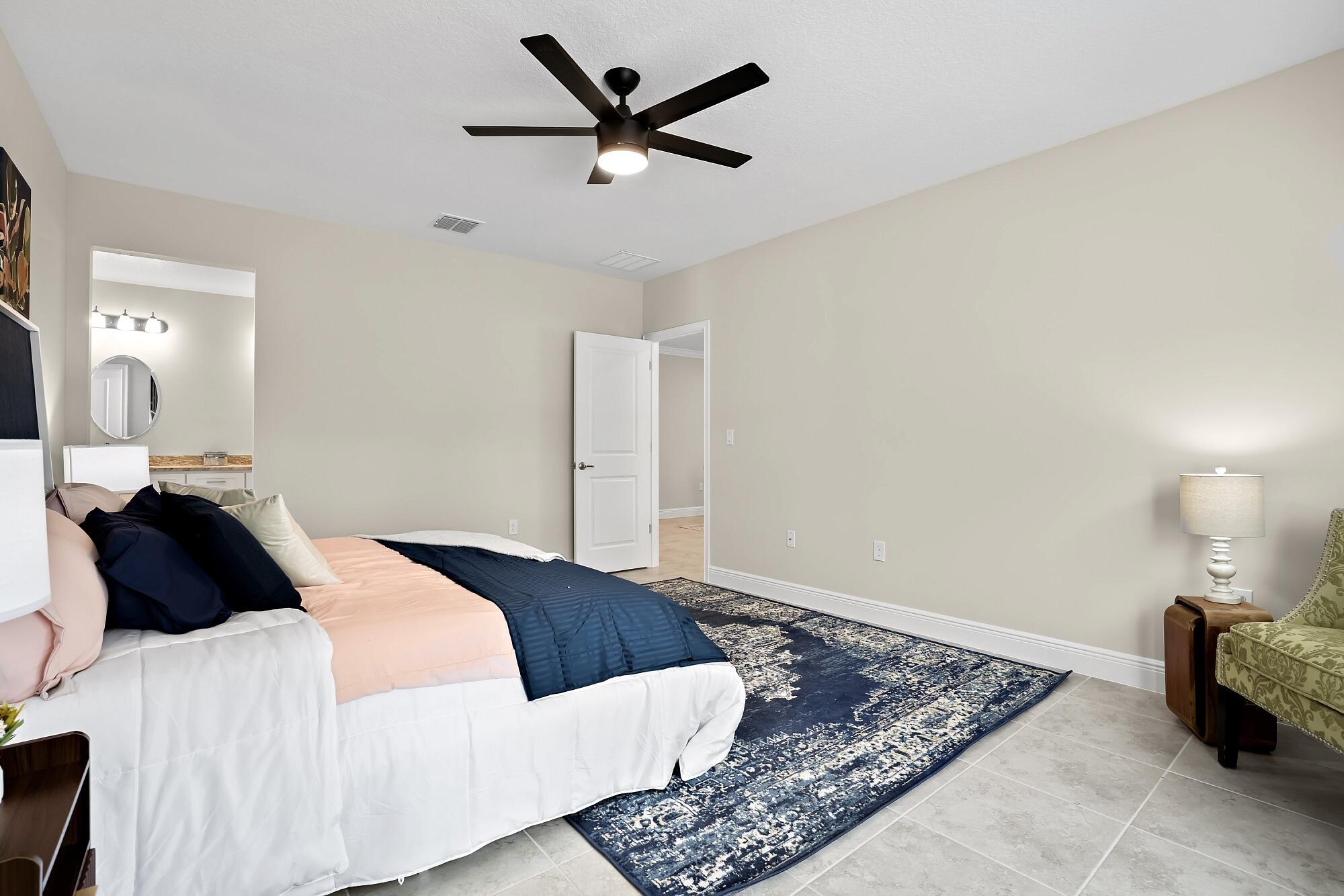 418 Easy Street Sebastian, FL 32958 - Photo 27 of 42 a bedroom with a bed and a painting on the wall