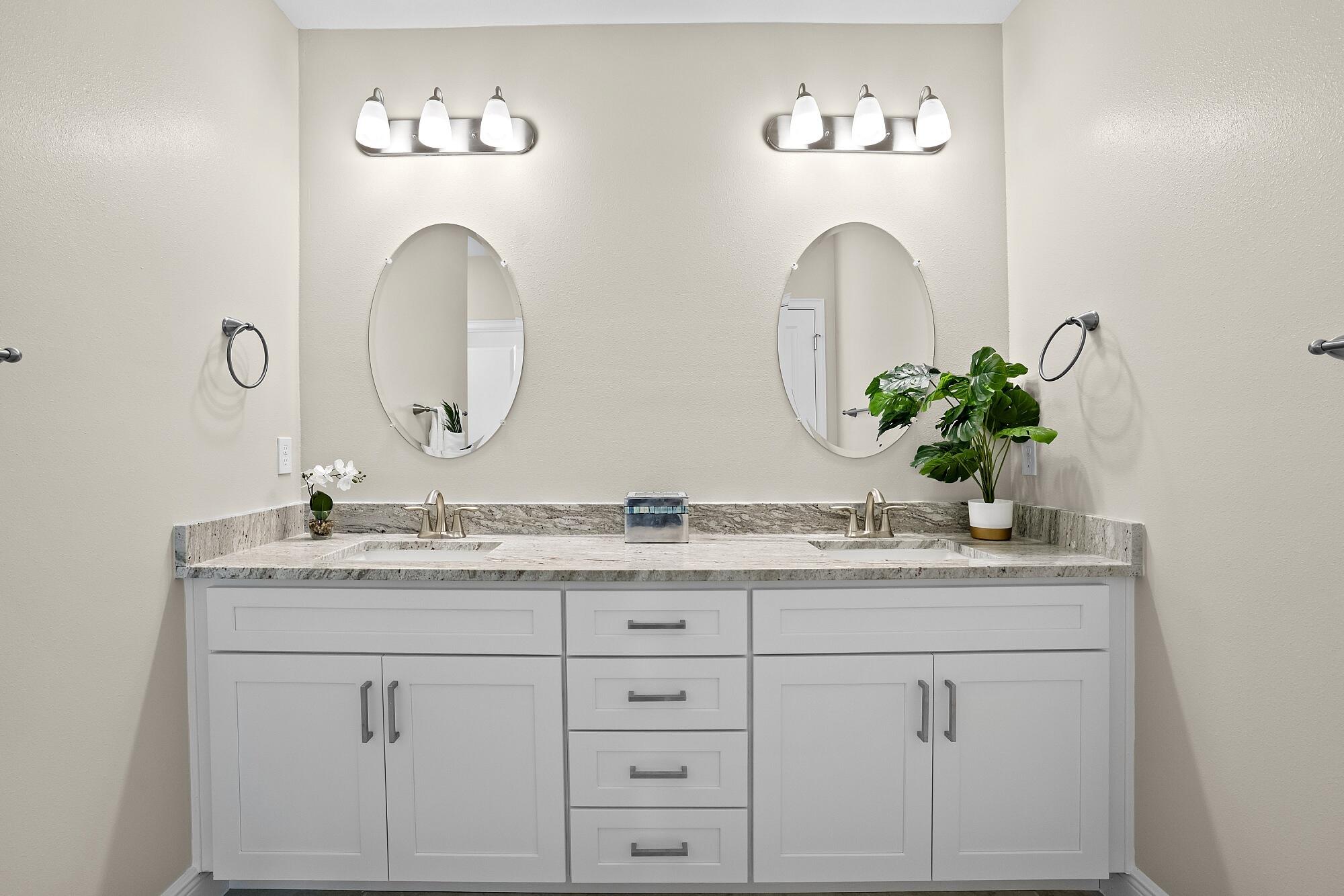 418 Easy Street Sebastian, FL 32958 - Photo 30 of 42 a bathroom with a granite countertop sink a mirror and a potted plant
