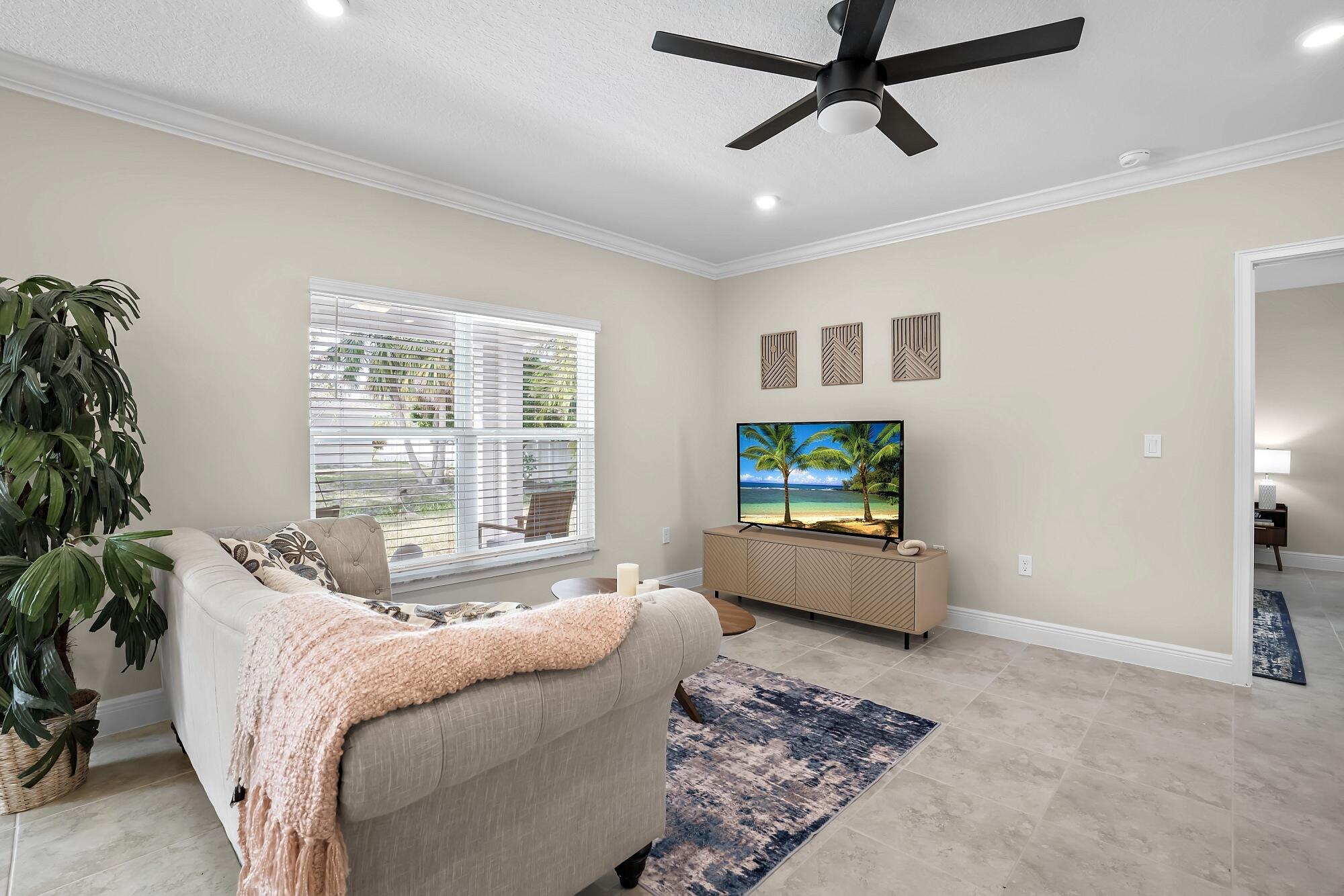 418 Easy Street Sebastian, FL 32958 - Photo 9 of 42 a living room with furniture and a flat screen tv