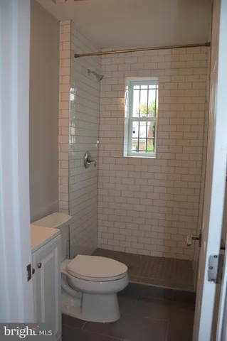 a bathroom with a toilet and shower