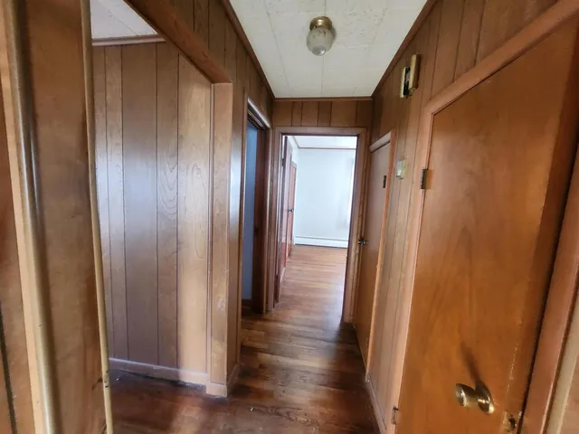 a view of hallway with wooden floor