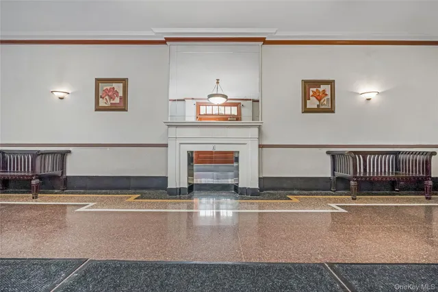 a living room with fireplace furniture and a ceiling fan