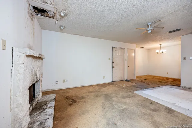 a view of empty room with ceiling fan