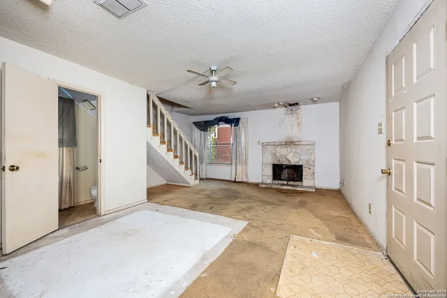 a view of a livingroom with an empty space and a fireplace