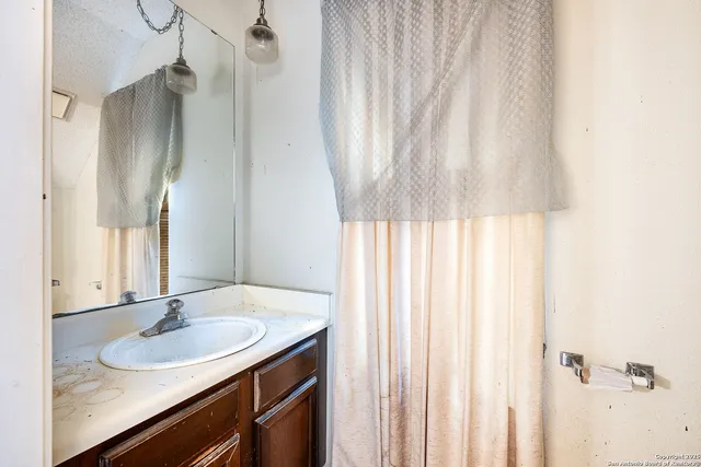 a bathroom with a sink and a mirror