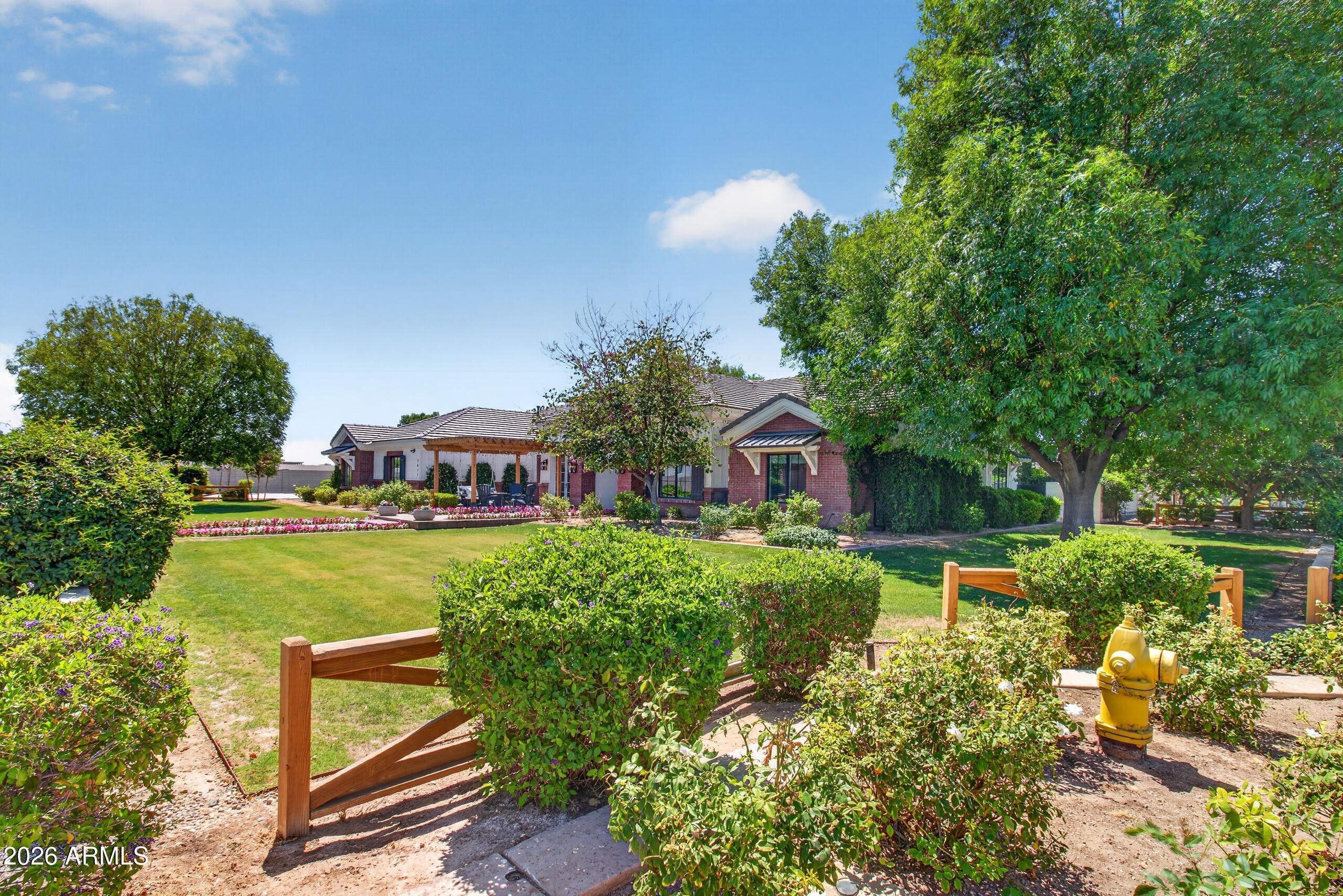 2677 East Queen Creek Road Gilbert, AZ 85297 - Photo 7 of 128 a view of a house with a big yard plants and large trees