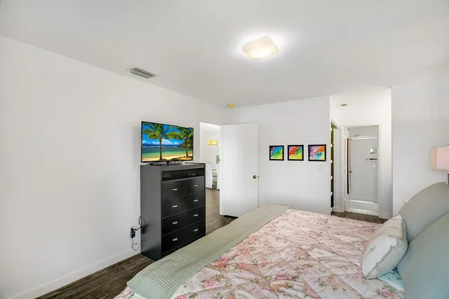 a bedroom with a bed and a television in it