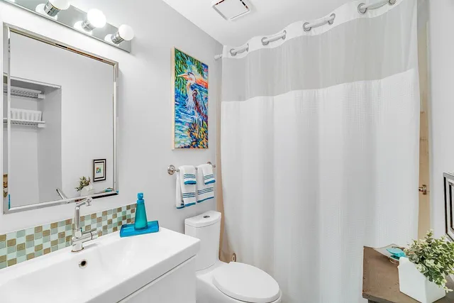 a bathroom with a sink toilet and shower