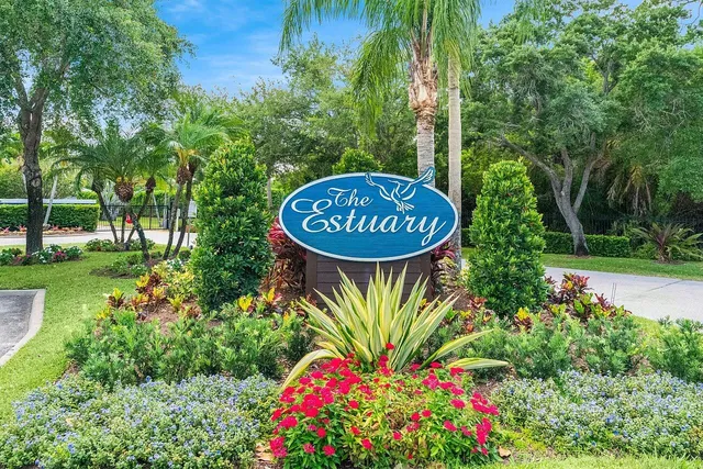 a sign that is sitting in front of flowers