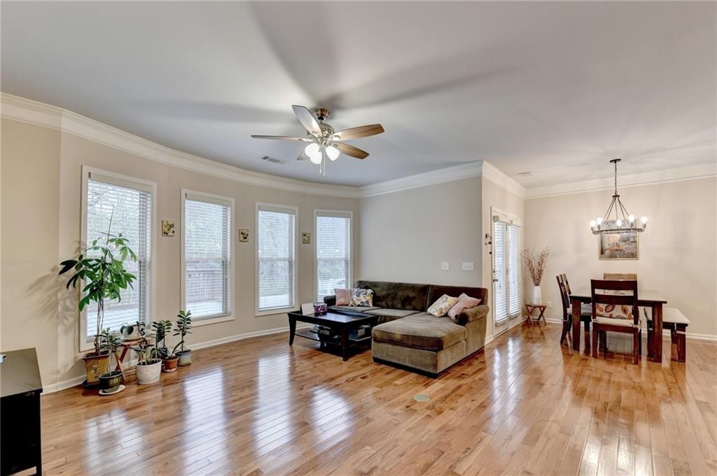 2455 Matlin Way Buford, GA 30519 - Photo 13 of 58 a living room with furniture and wooden floor