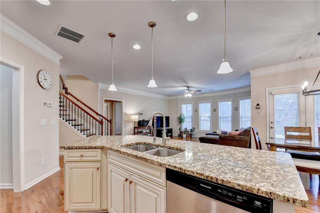 2455 Matlin Way Buford, GA 30519 - Photo 20 of 58 a kitchen with stainless steel appliances kitchen island granite countertop a sink and cabinets