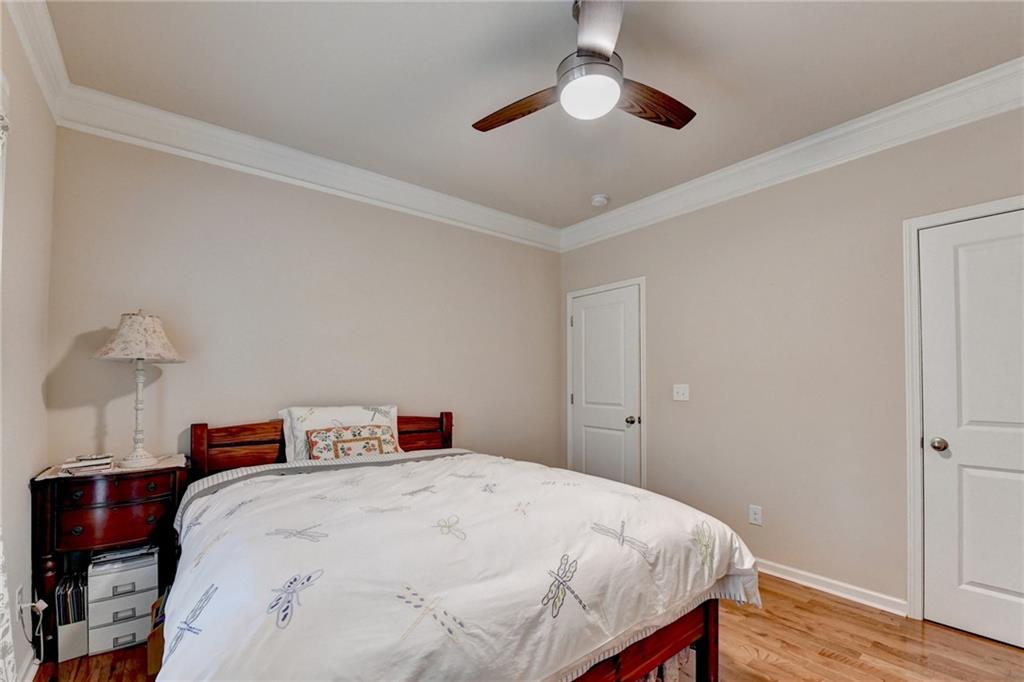 2455 Matlin Way Buford, GA 30519 - Photo 28 of 58 a bedroom with a bed and a chandelier