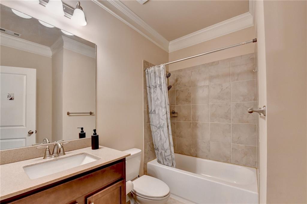 2455 Matlin Way Buford, GA 30519 - Photo 30 of 58 a bathroom with a sink toilet and shower