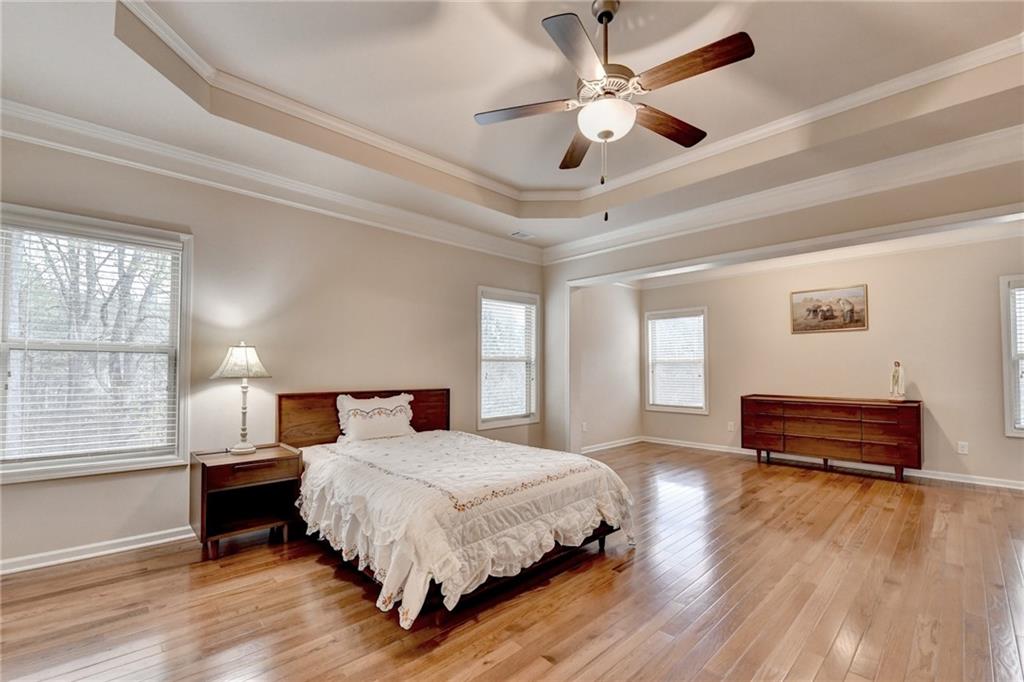 2455 Matlin Way Buford, GA 30519 - Photo 35 of 58 a bedroom with a bed wooden floor and window