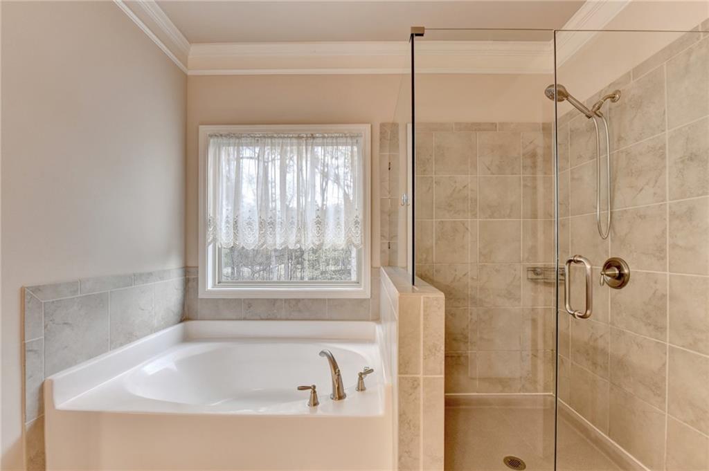 2455 Matlin Way Buford, GA 30519 - Photo 39 of 58 a white bath tub sitting in a bathroom next to a window