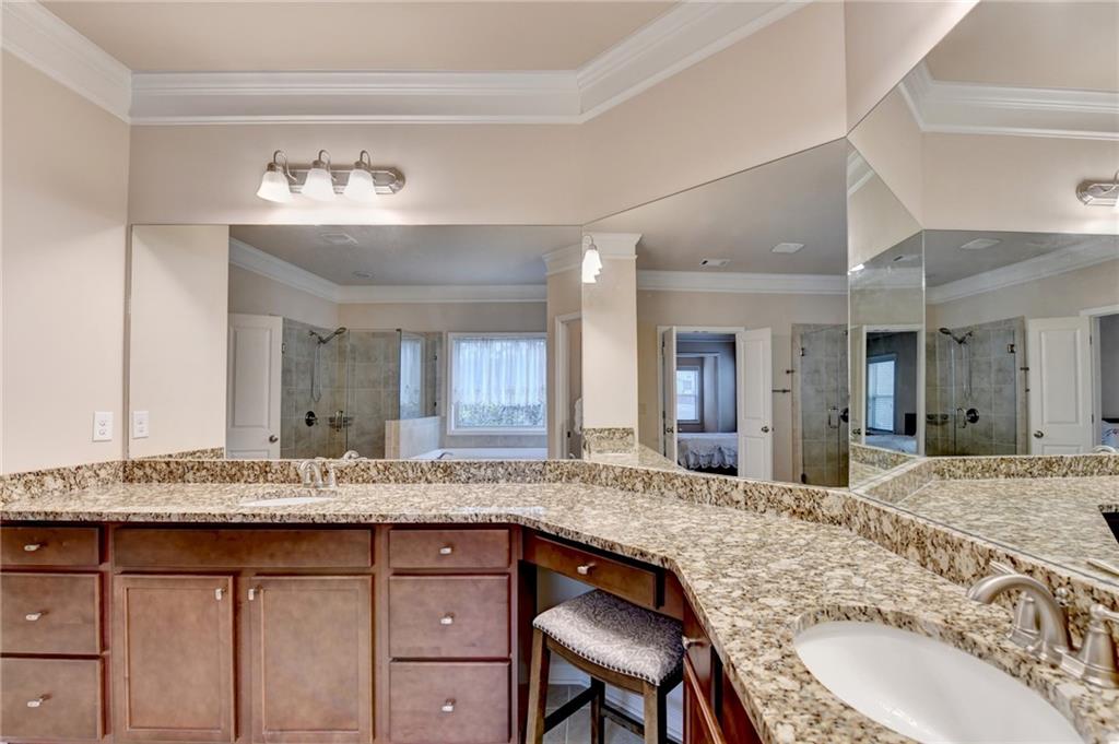 2455 Matlin Way Buford, GA 30519 - Photo 40 of 58 a bathroom with a granite countertop double vanity sink and a mirror