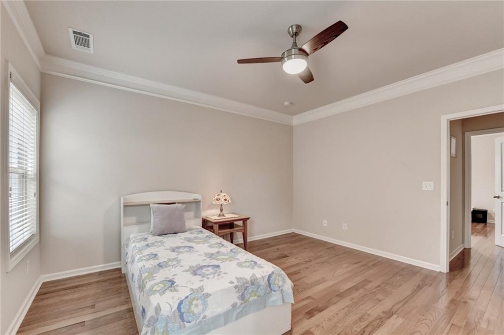 2455 Matlin Way Buford, GA 30519 - Photo 44 of 58 a bedroom with a bed and a chandelier