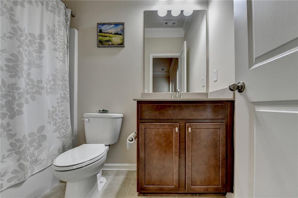 2455 Matlin Way Buford, GA 30519 - Photo 45 of 58 a bathroom with a toilet and a sink