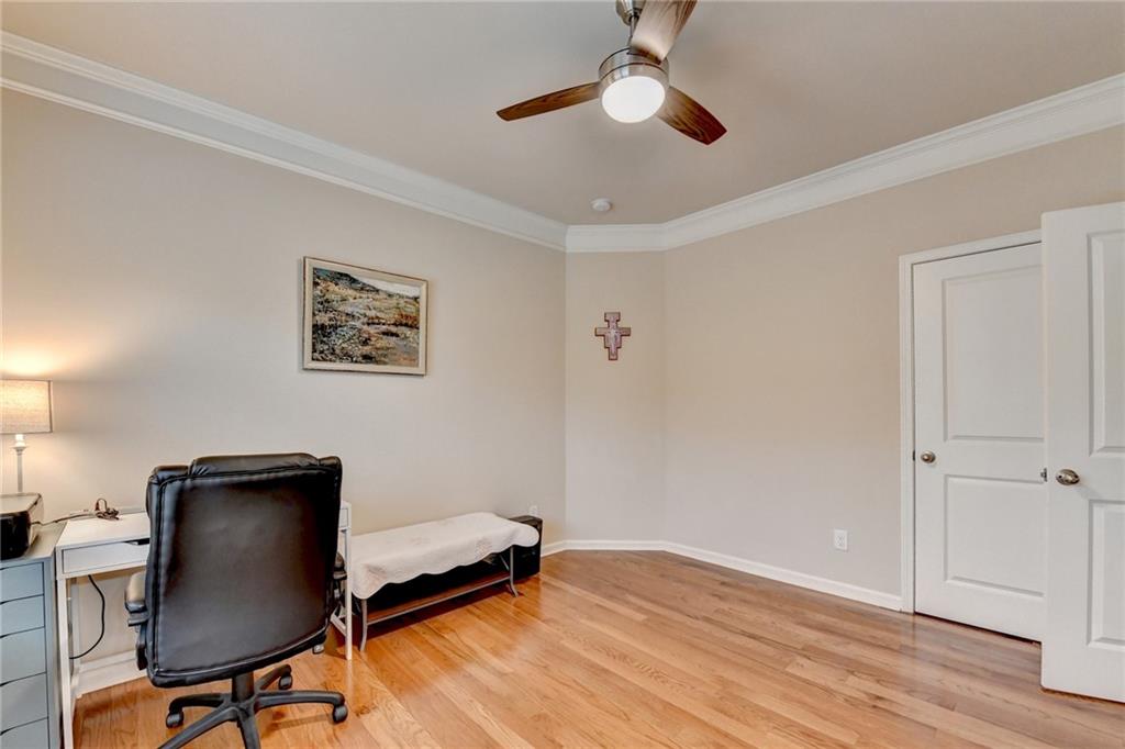 2455 Matlin Way Buford, GA 30519 - Photo 48 of 58 a bedroom with a chair and a ceiling fan