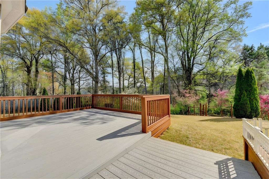 2455 Matlin Way Buford, GA 30519 - Photo 50 of 58 a street view with wooden fence and trees