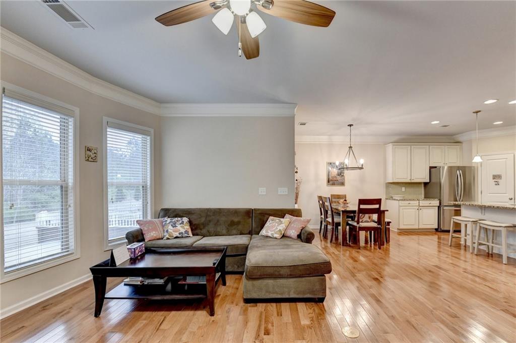 2455 Matlin Way Buford, GA 30519 - Photo 10 of 58 a living room with furniture kitchen view and a large window