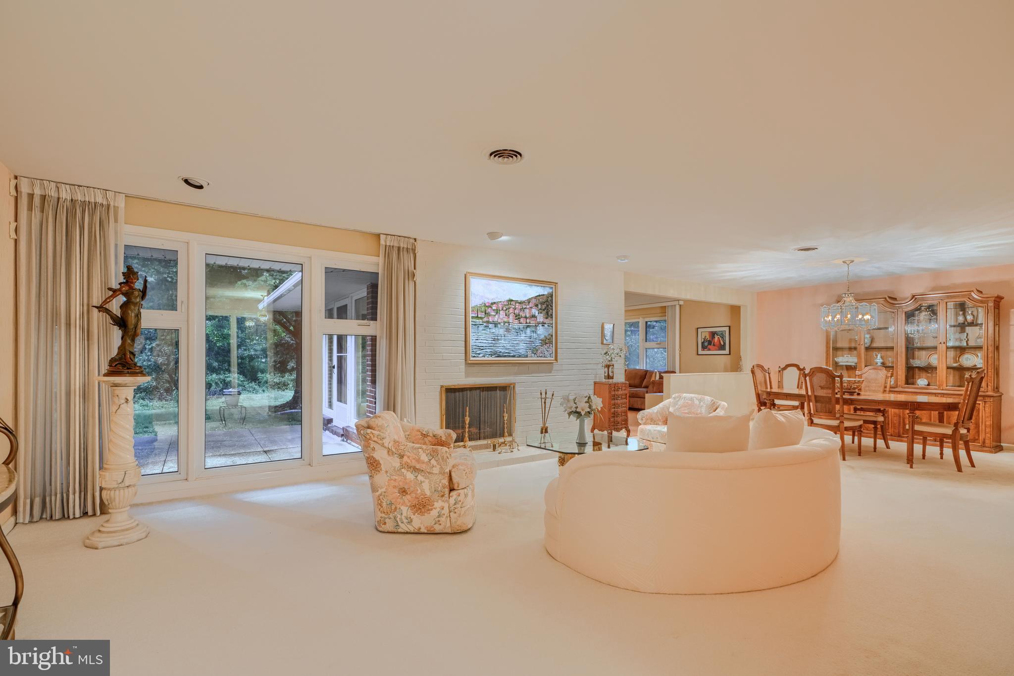 7900 Ivy Lane Baltimore, MD 21208 - Photo 13 of 32 a living room with fireplace furniture and a large window