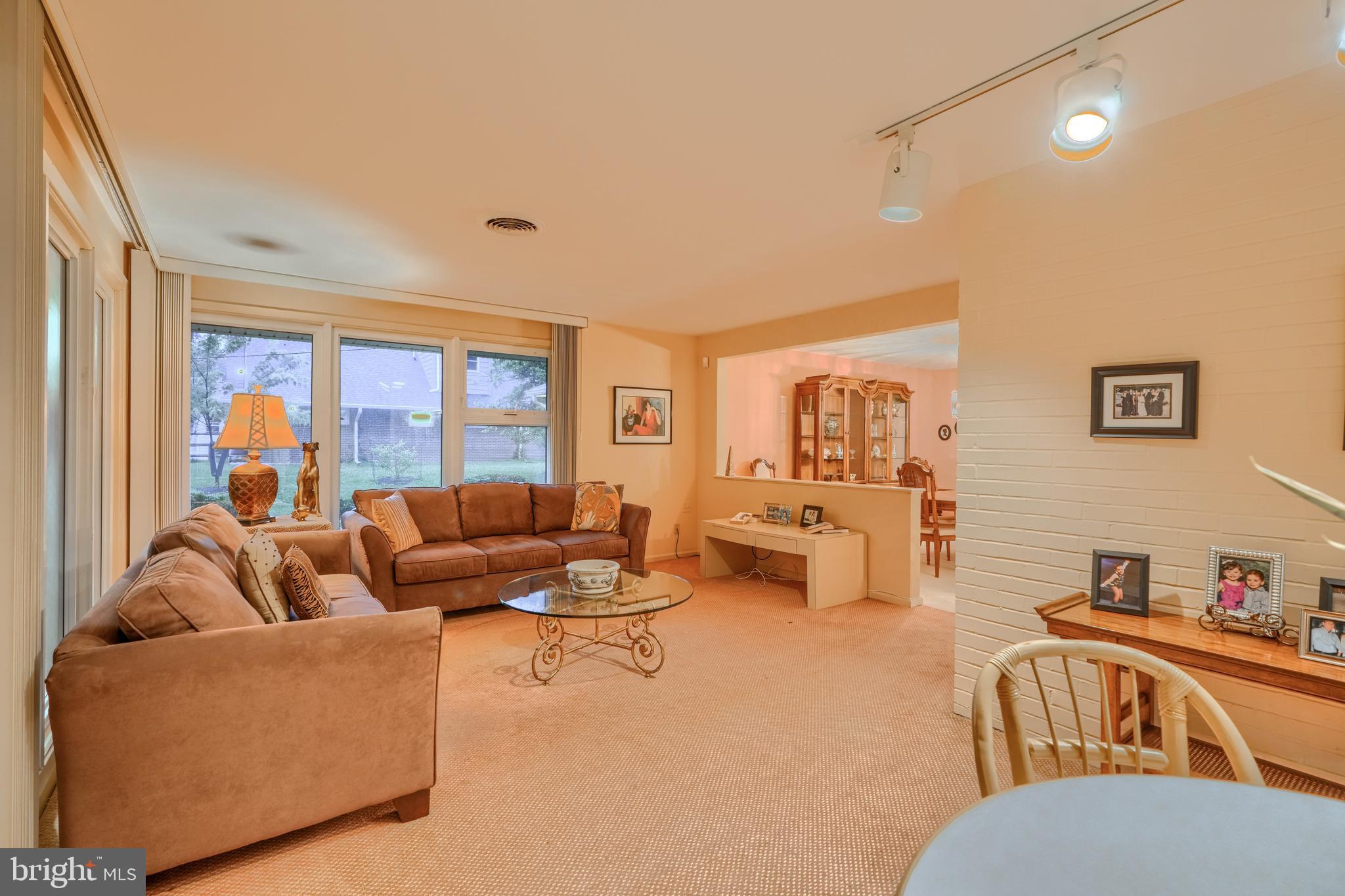 7900 Ivy Lane Baltimore, MD 21208 - Photo 16 of 32 a living room with furniture and a flat screen tv