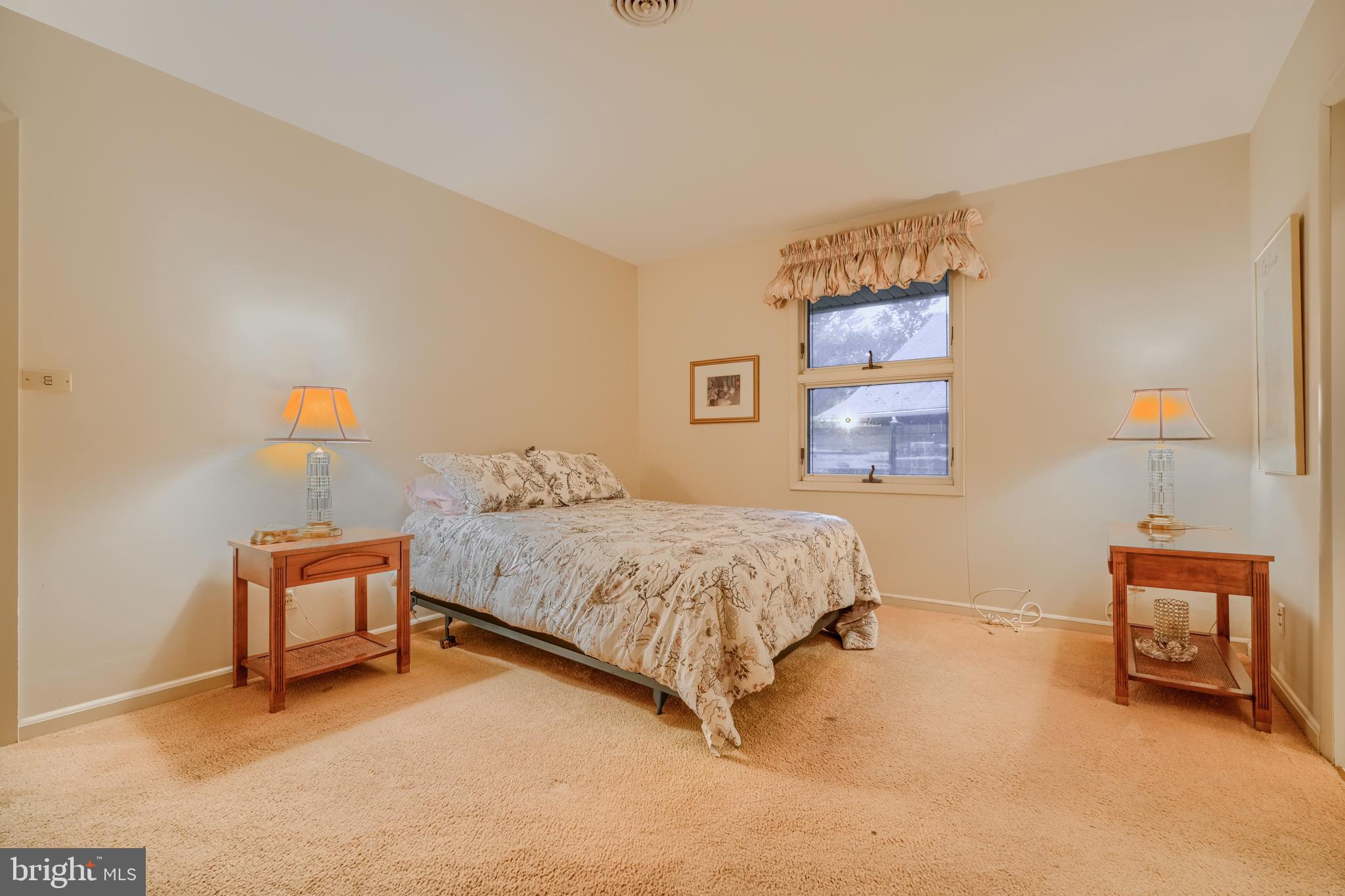 7900 Ivy Lane Baltimore, MD 21208 - Photo 24 of 32 a bedroom with a bed and a chair