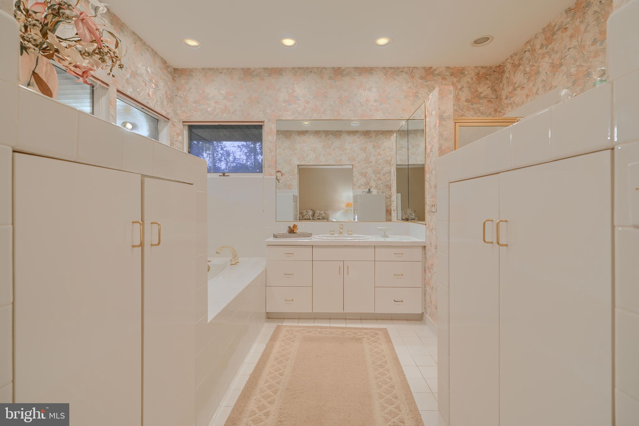 7900 Ivy Lane Baltimore, MD 21208 - Photo 25 of 32 a bathroom with a sink mirror and a shower
