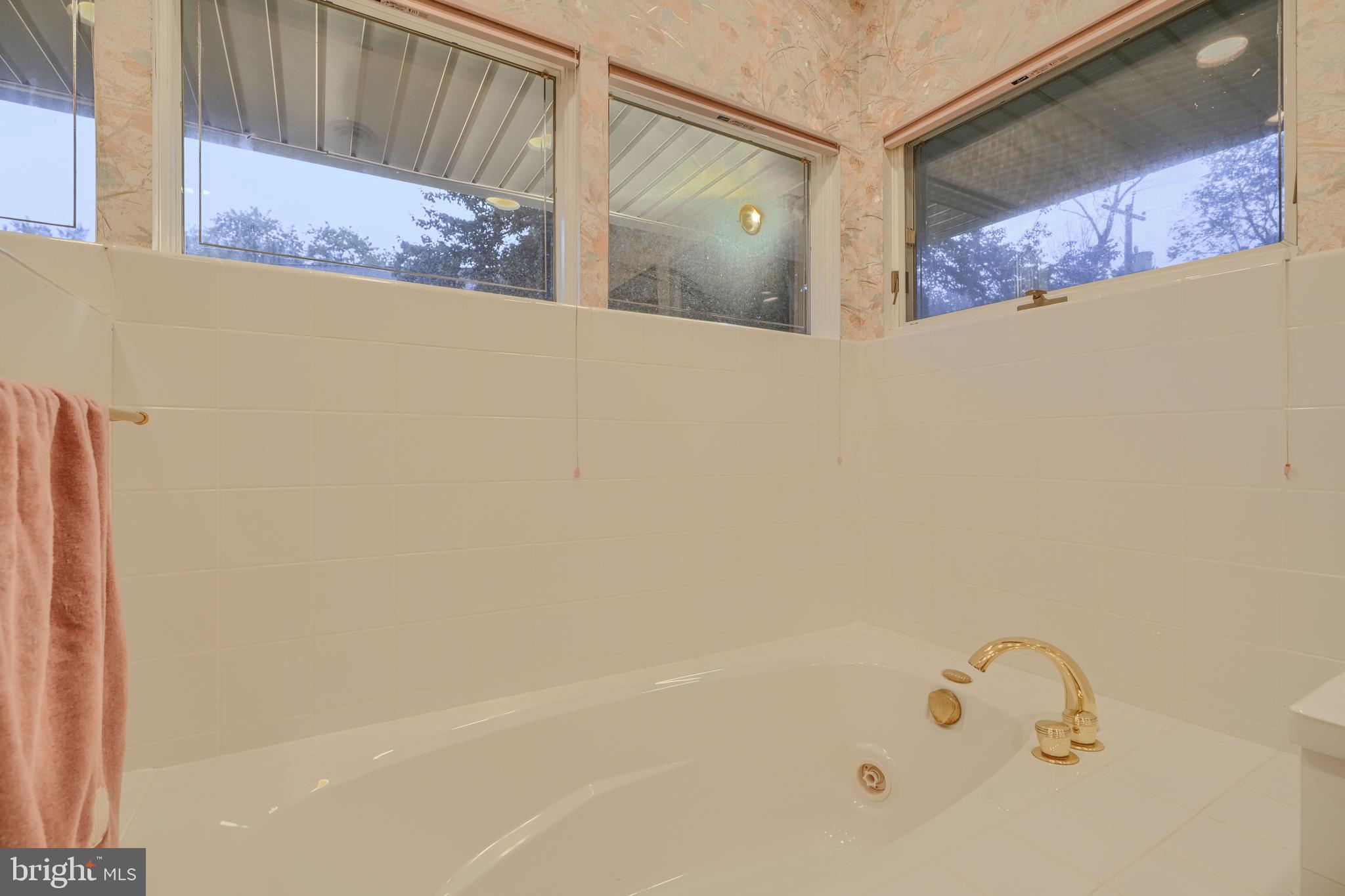 7900 Ivy Lane Baltimore, MD 21208 - Photo 27 of 32 a bathroom with a bathtub and shower