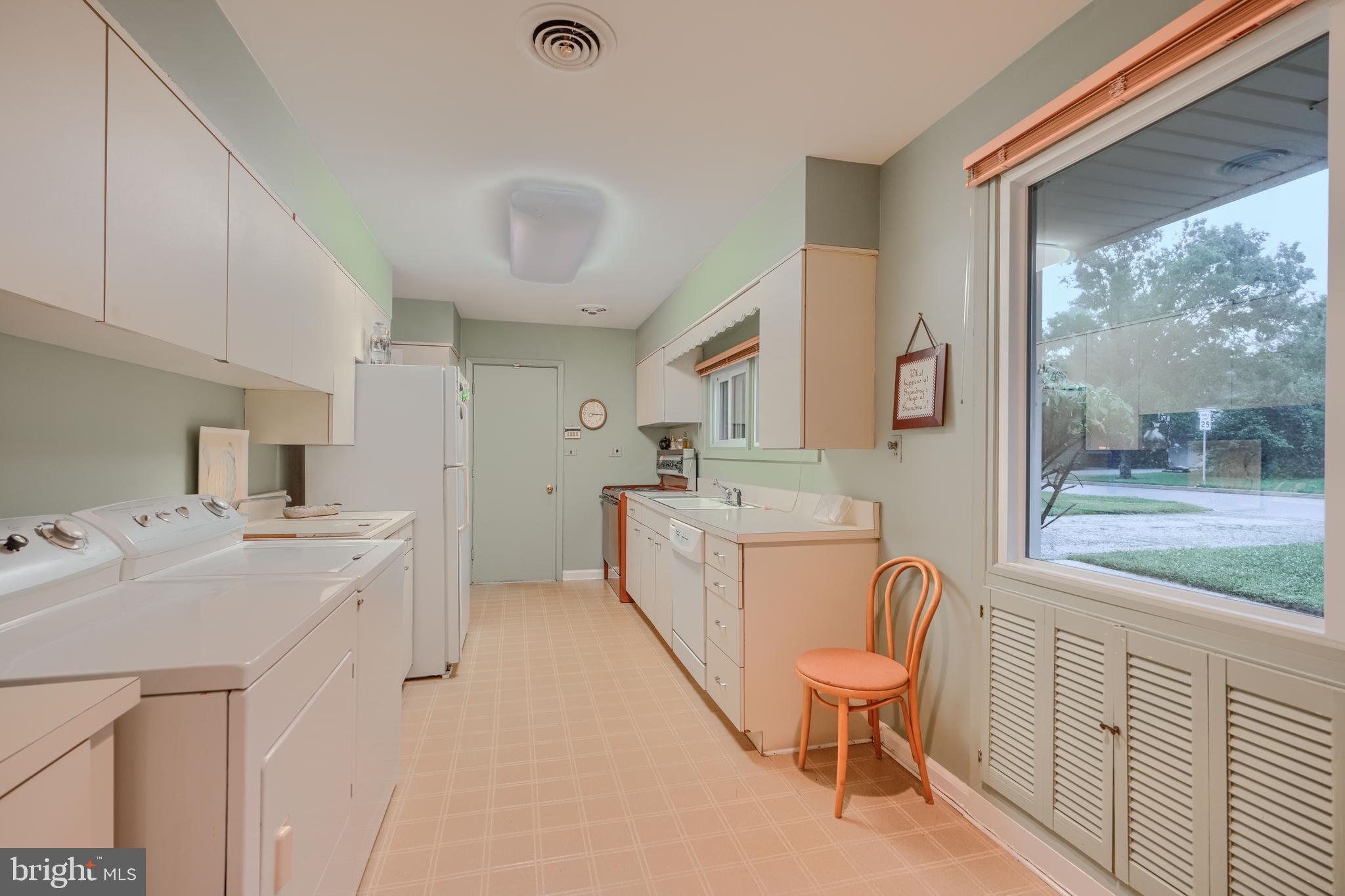 7900 Ivy Lane Baltimore, MD 21208 - Photo 6 of 32 a bathroom with a sink a toilet and a large mirror