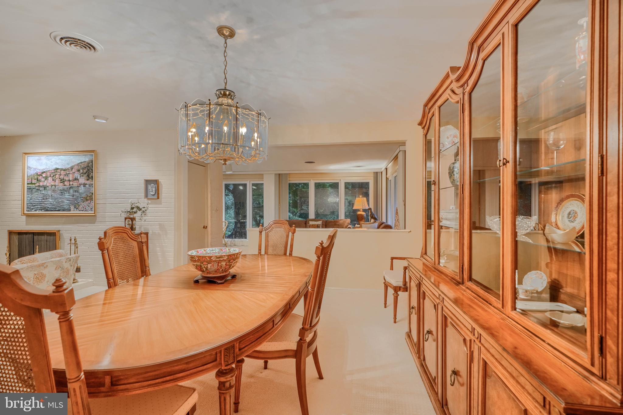 7900 Ivy Lane Baltimore, MD 21208 - Photo 9 of 32 a view of a dining room with furniture a chandelier and wooden floor