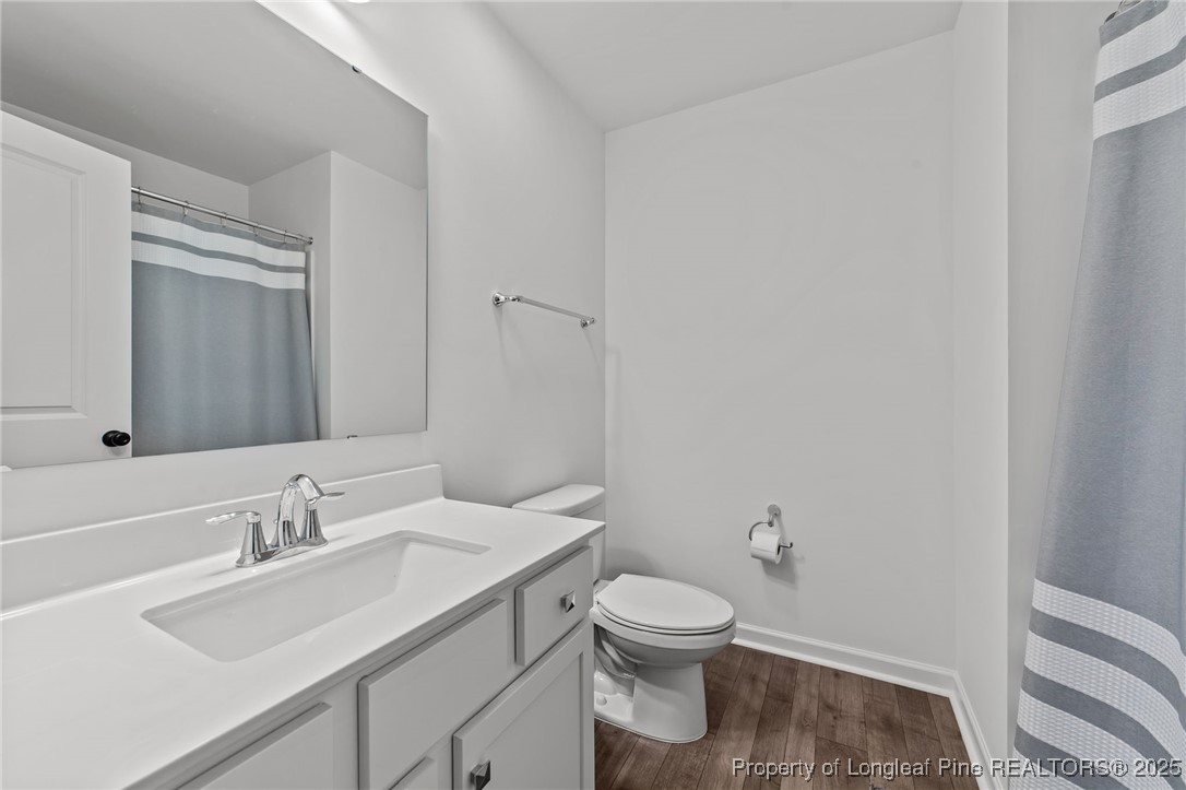 96 Periwinkle Place Clayton, NC 27527 - Photo 13 of 19 a bathroom with a sink toilet and vanity