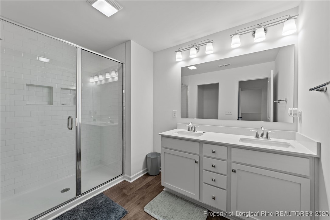 96 Periwinkle Place Clayton, NC 27527 - Photo 18 of 19 a bathroom with a double vanity sink mirror and shower