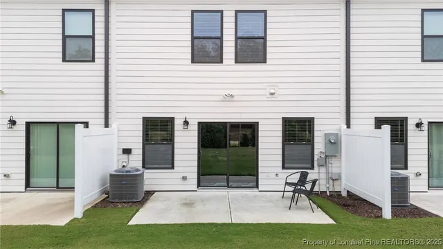 a view of a house with backyard and porch