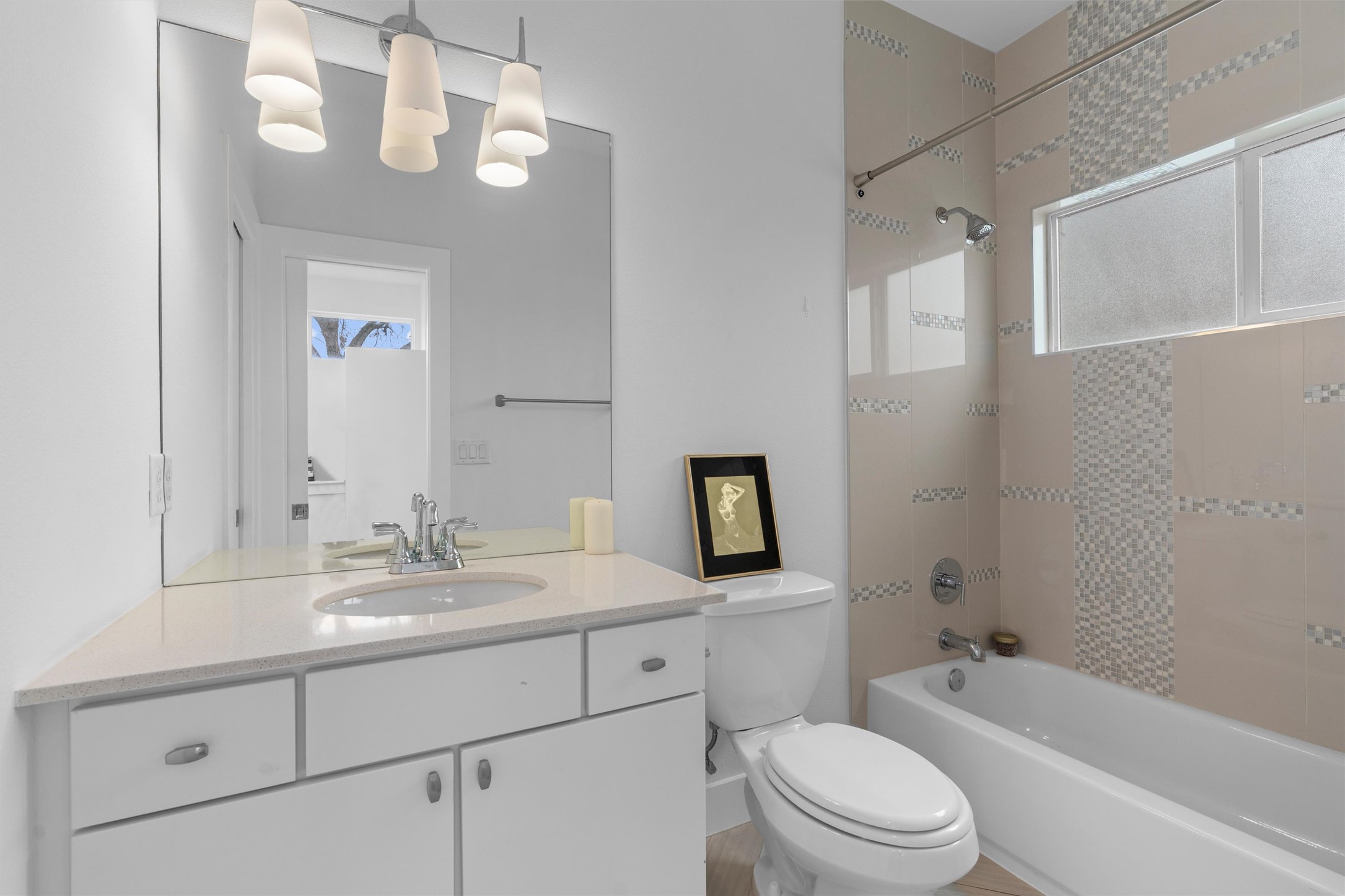 2514 East 4th Street, Unit B Austin, TX 78702 - Photo 18 of 22 a bathroom with a toilet a sink a tub and mirror