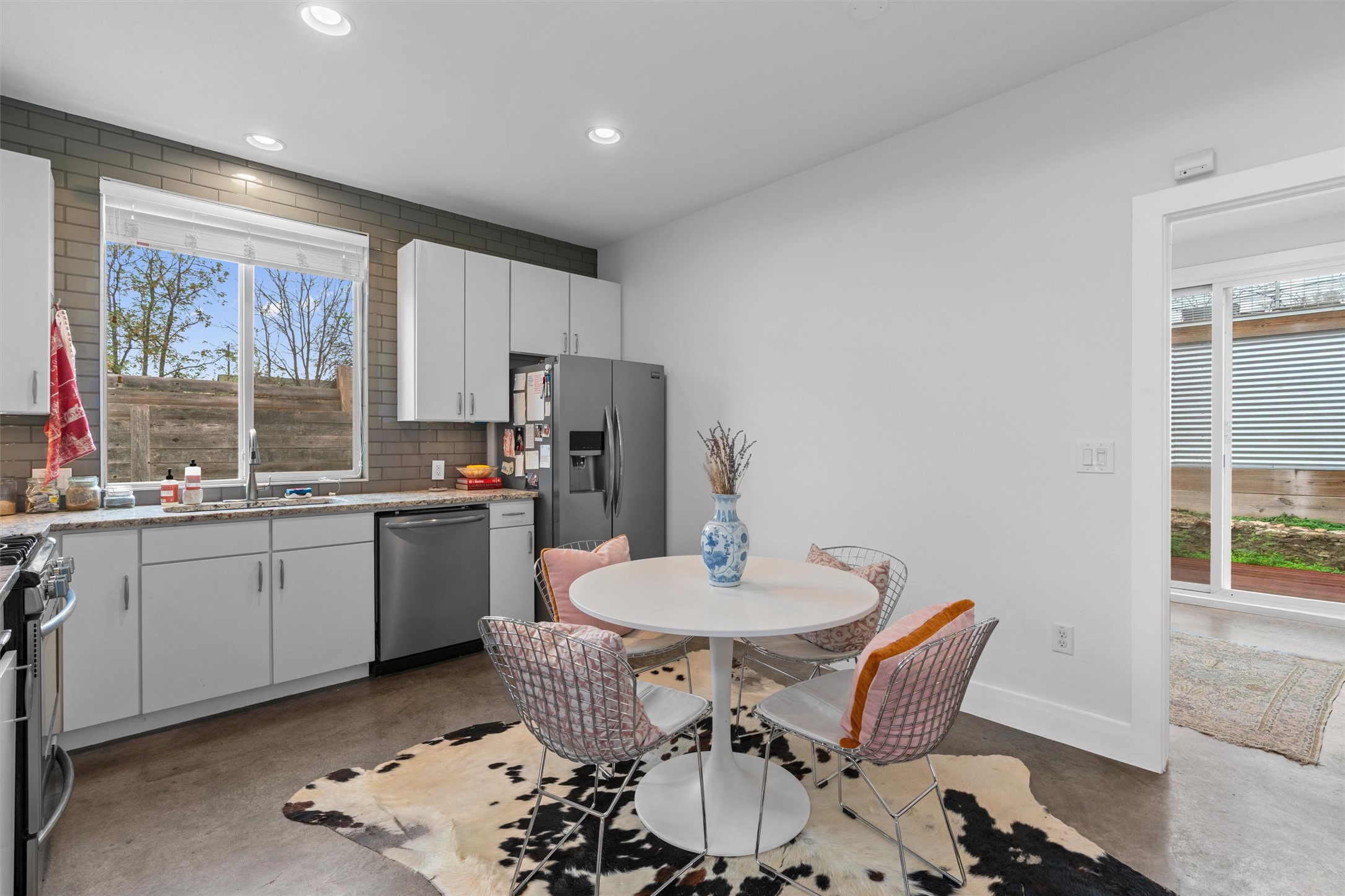 2514 East 4th Street, Unit B Austin, TX 78702 - Photo 5 of 22 a kitchen with a dining table chairs and refrigerator