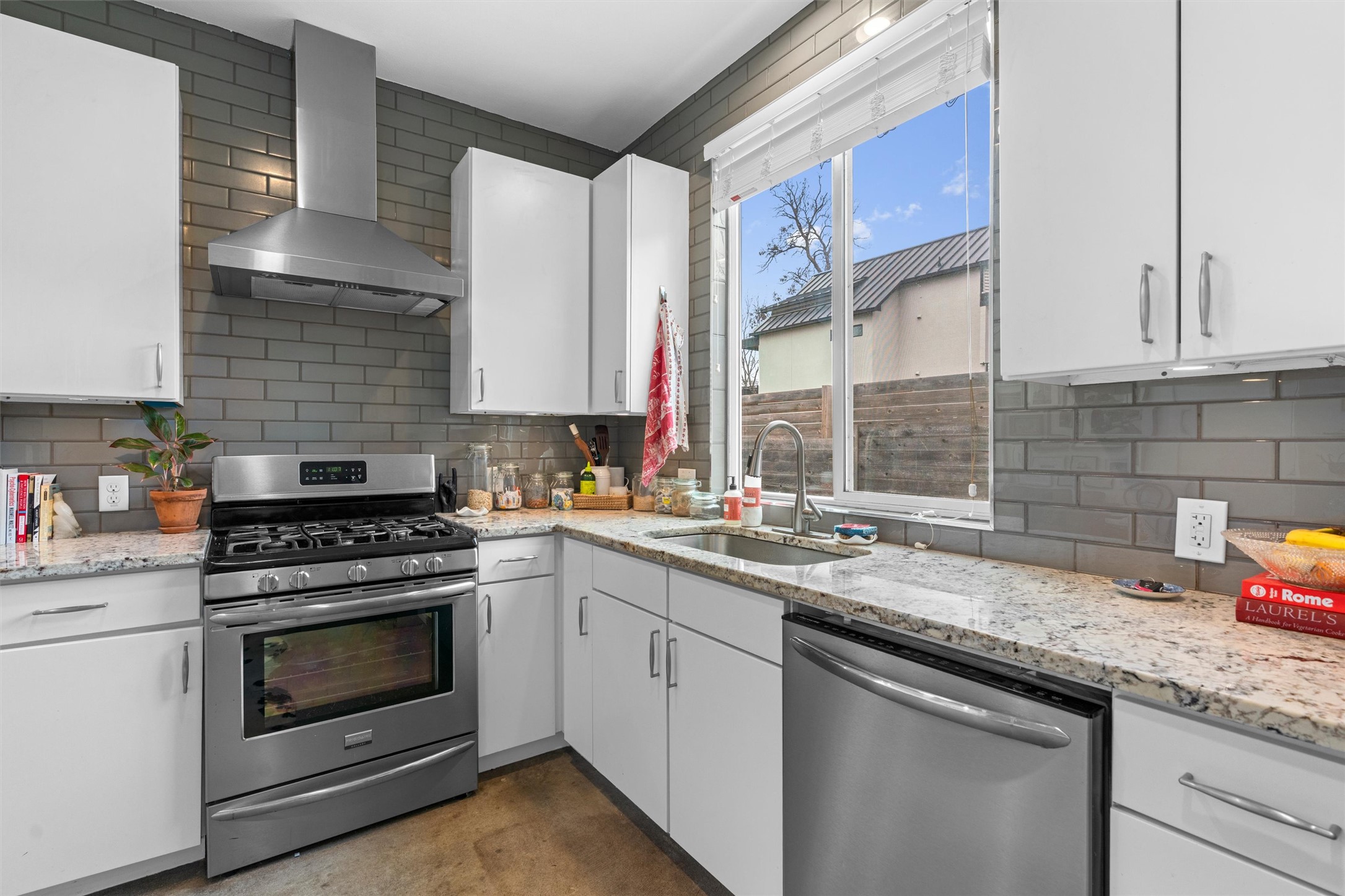 2514 East 4th Street, Unit B Austin, TX 78702 - Photo 7 of 22 a kitchen with stainless steel appliances granite countertop a sink a stove and cabinets
