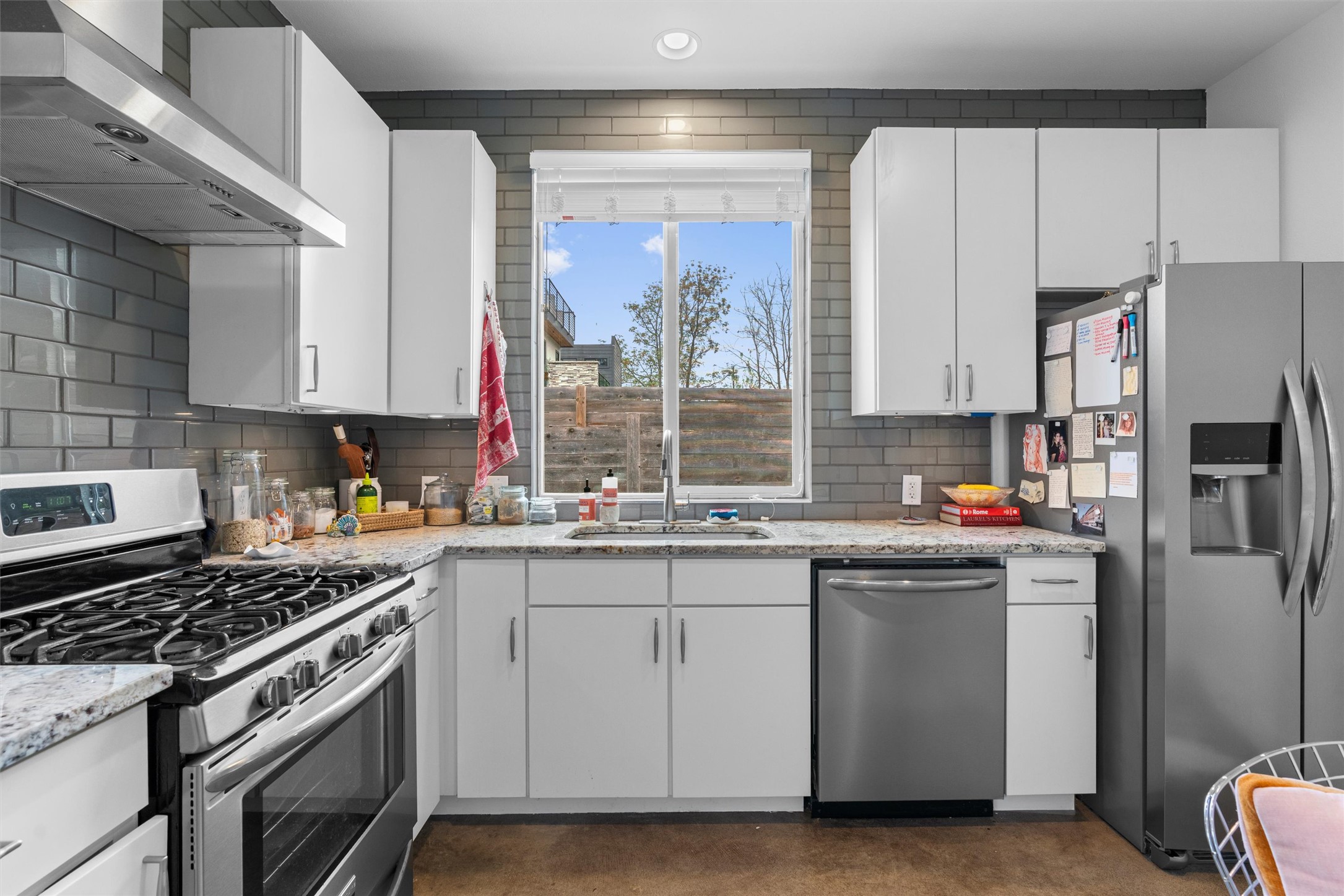 2514 East 4th Street, Unit B Austin, TX 78702 - Photo 8 of 22 a kitchen with stainless steel appliances a sink stove and refrigerator