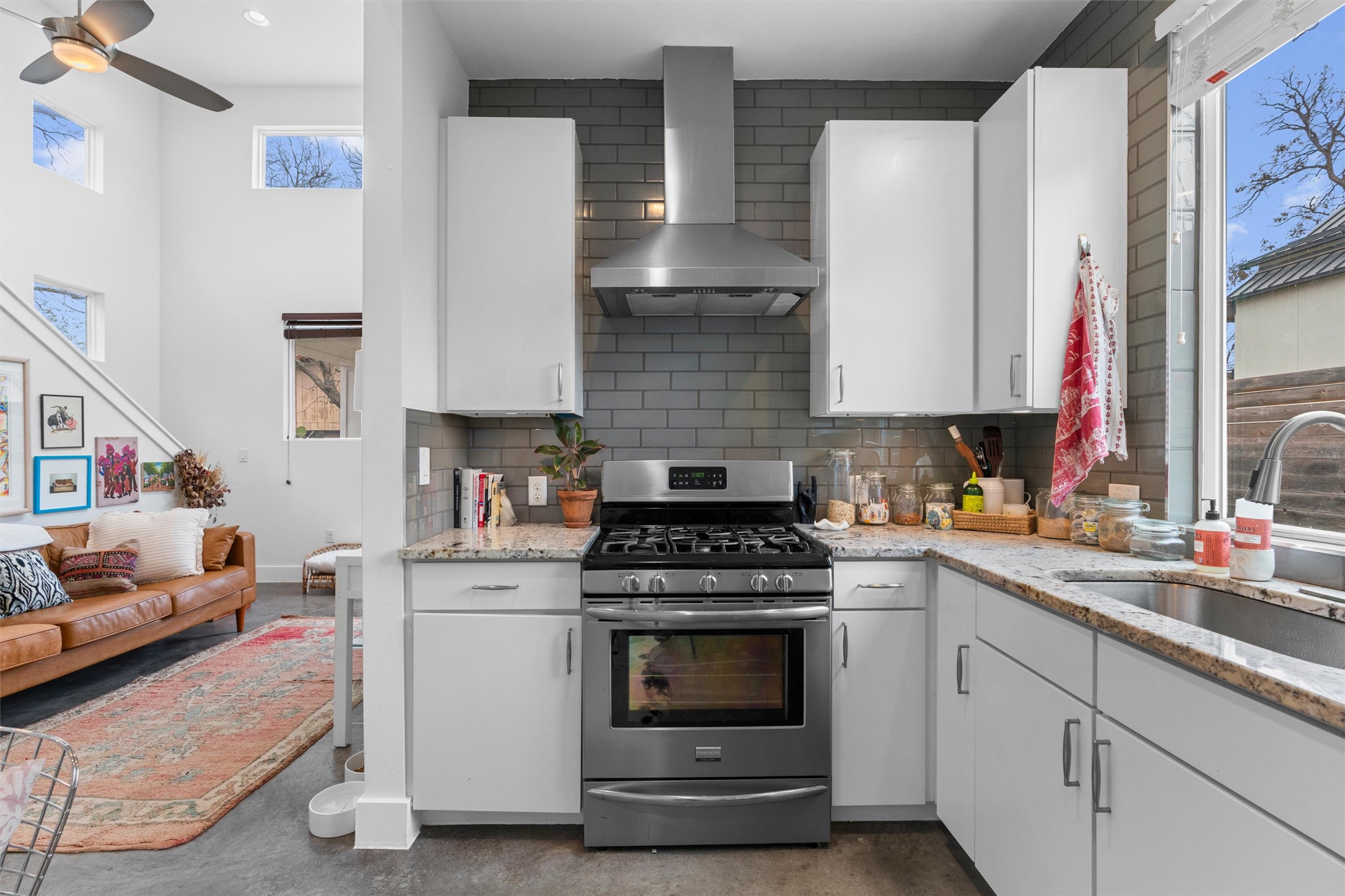 2514 East 4th Street, Unit B Austin, TX 78702 - Photo 9 of 22 a kitchen with white cabinets and white appliances