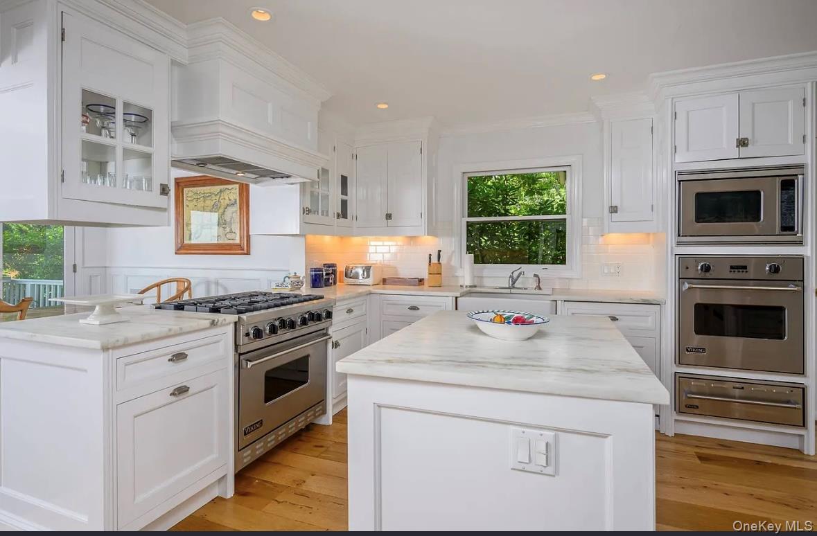 972 Noyac Path Water Mill, NY 11976 - Photo 15 of 40 a kitchen with stainless steel appliances white cabinets and a stove top oven