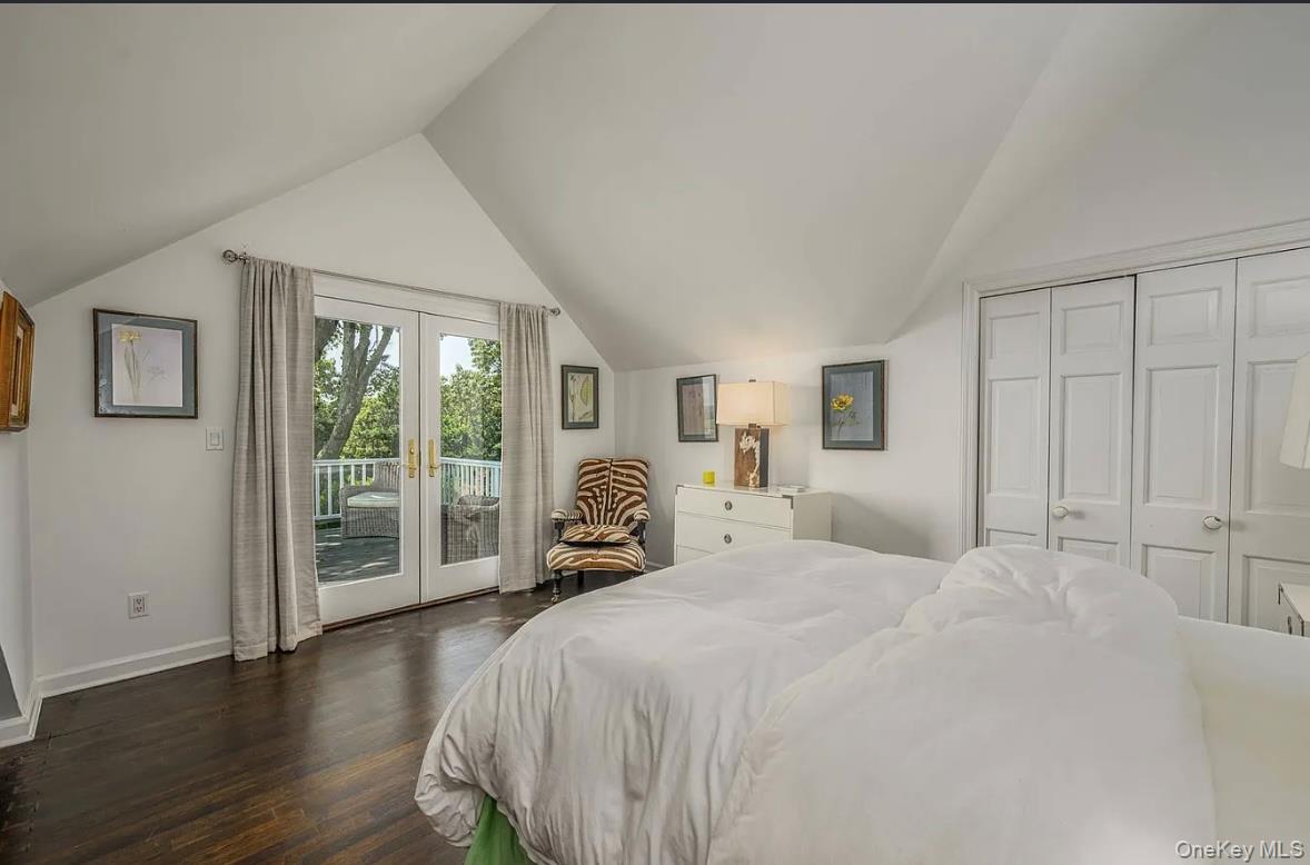 972 Noyac Path Water Mill, NY 11976 - Photo 25 of 40 a bedroom with a large bed and a large window
