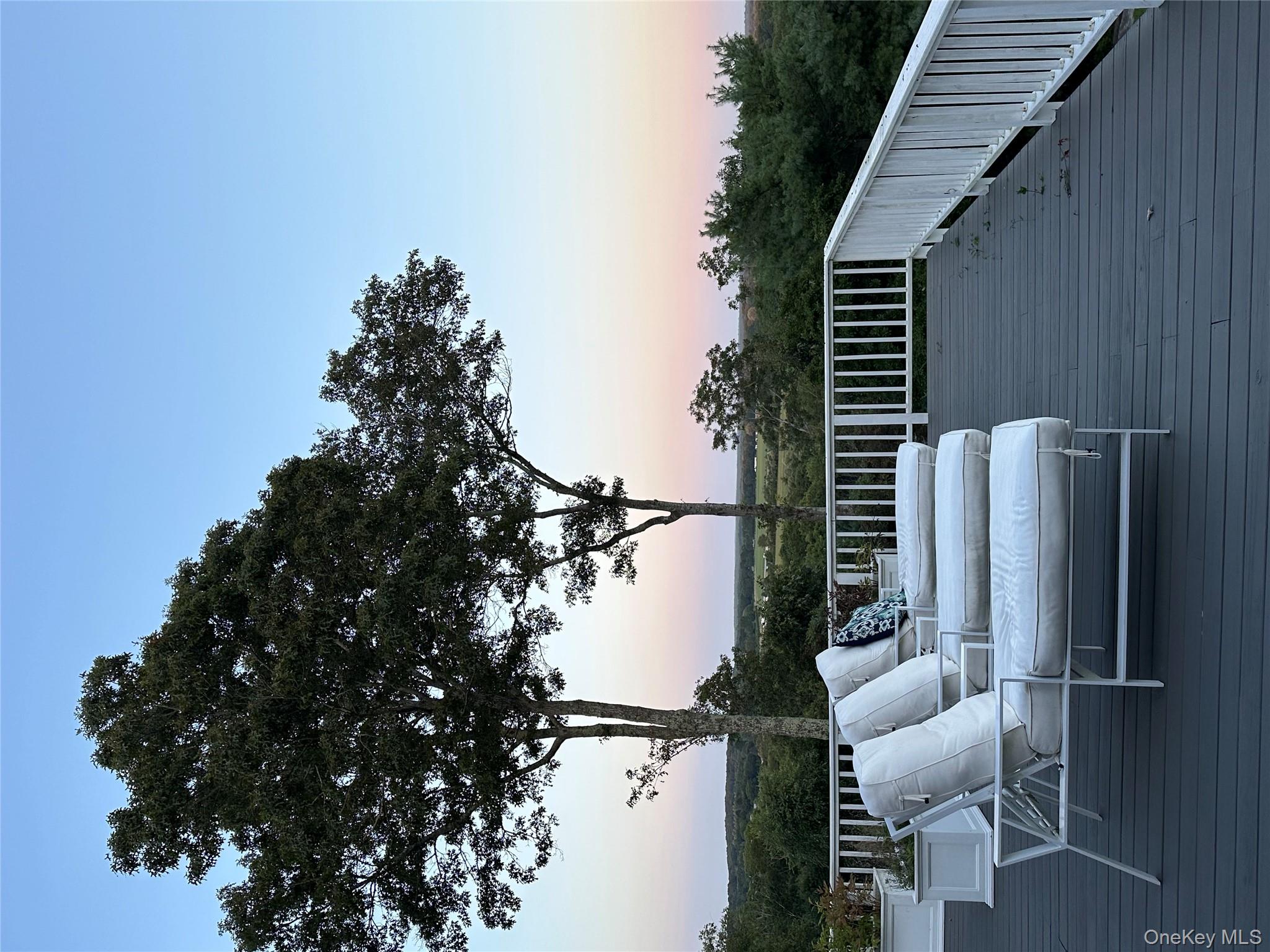 972 Noyac Path Water Mill, NY 11976 - Photo 10 of 40 a view of balcony with furniture and trees