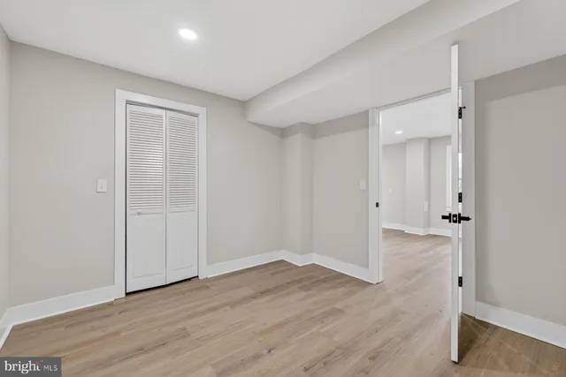 a view of a room with wooden floor