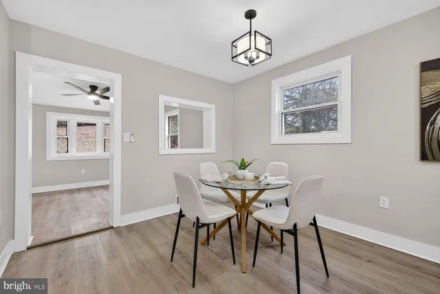 a view of a dining room with furniture wooden floor and a window