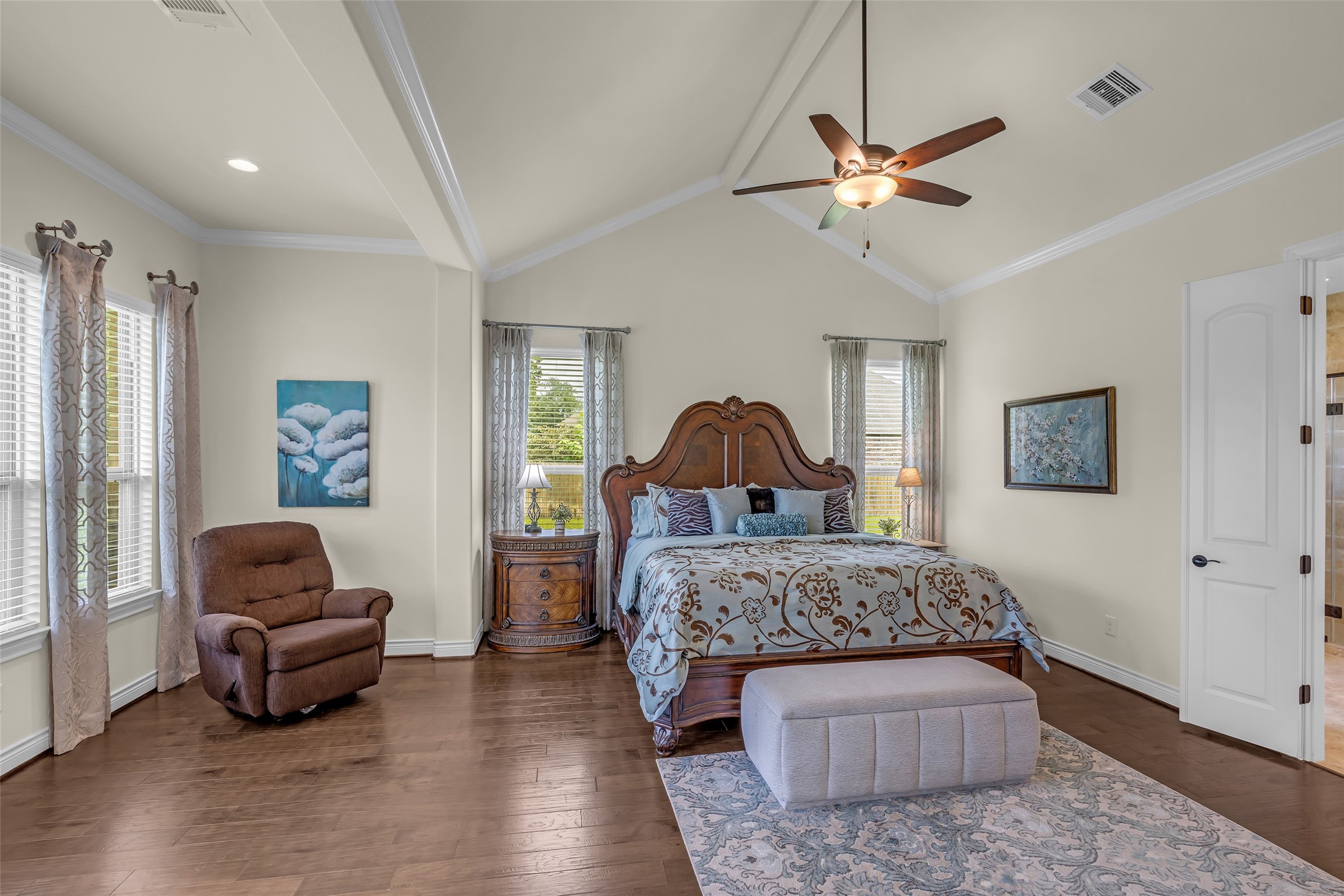 14003 South Evergreen Ridge Court Conroe, TX 77384 - Photo 22 of 43 Hardwood floors continue into the primary suite, where vaulted ceilings create an open, inviting retreat.