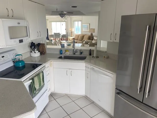a kitchen with a sink appliances and cabinets