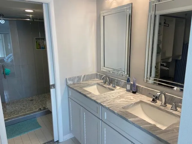 a bathroom with a granite countertop sink and a mirror